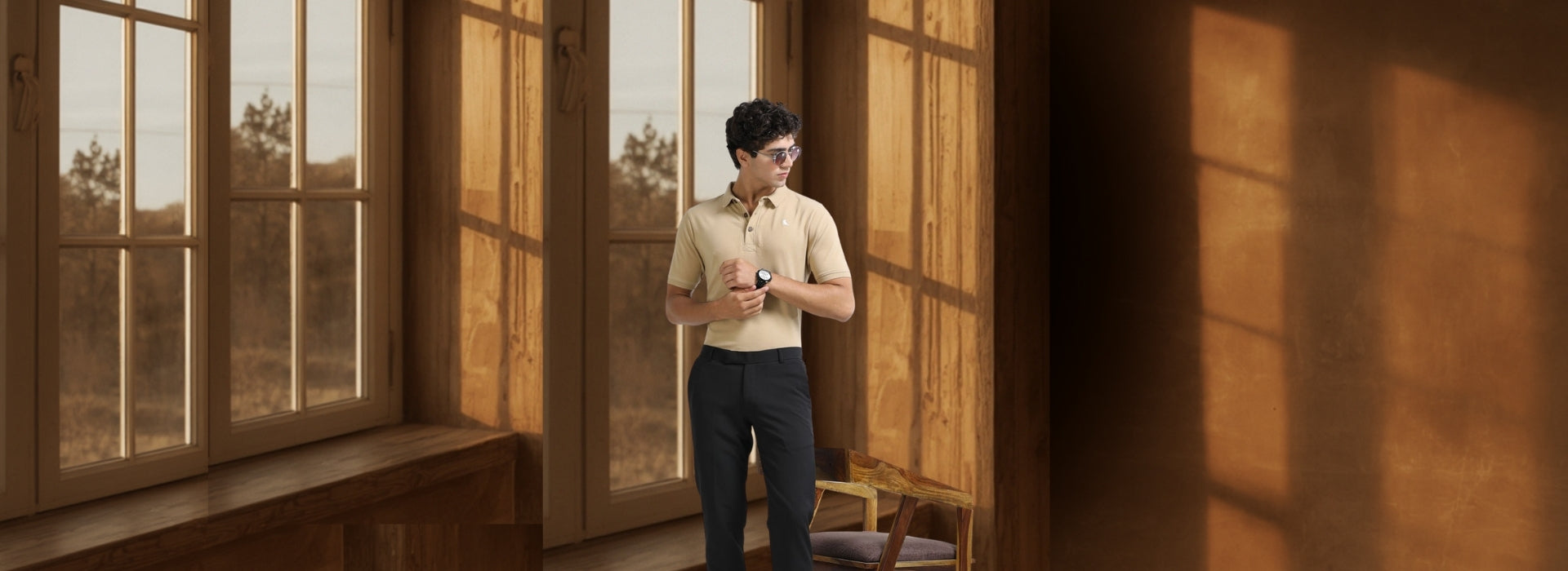 Man standing in a sunlit room with large windows